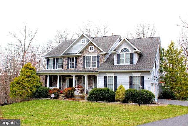 6 Copewood Ct, Manchester, MD 21102 - view of front of house with aphalt driveway, covered porch, stone siding, a front lawn, and a shingled roof
