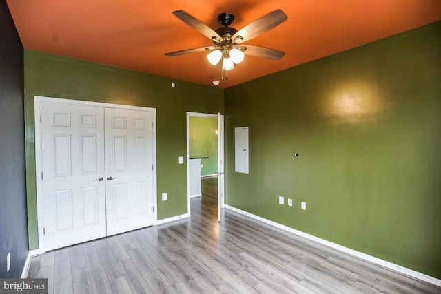1341 Karen Blvd Unit 404, Capitol Heights, MD 20743 - unfurnished bedroom with wood finished floors, a closet, baseboards, and a ceiling fan