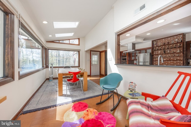 interior space featuring a skylight, visible vents, and plenty of natural light