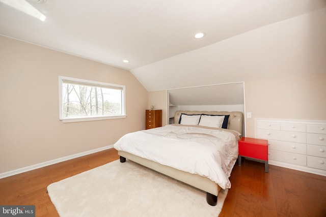 bedroom with wood finished floors, baseboards, vaulted ceiling, and recessed lighting