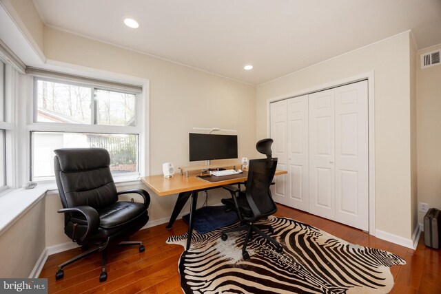 office featuring recessed lighting, visible vents, baseboards, and wood finished floors