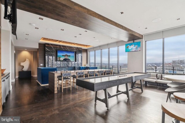 recreation room featuring expansive windows and beamed ceiling