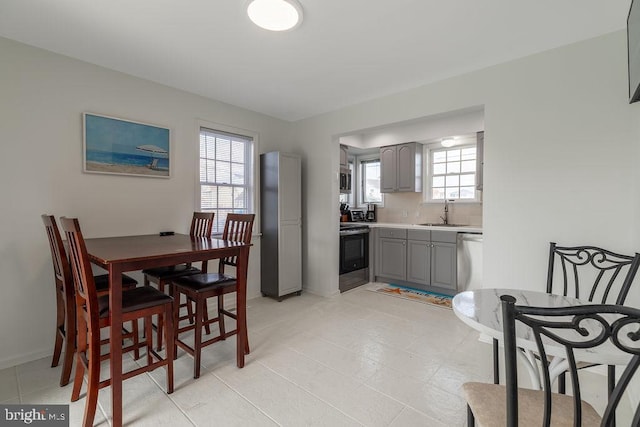 10429 Brighton Rd, Ocean City, MD 21842 - dining space with baseboards and light tile patterned floors