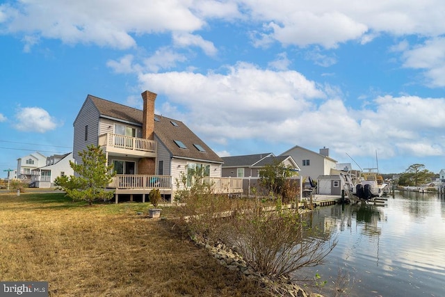 10429 Brighton Rd, Ocean City, MD 21842 - rear view of house featuring a lawn, a chimney, and a water view