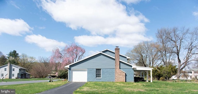768 Lexington Ave, Hershey, PA 17033 - view of property exterior with brick siding, a lawn, driveway, and a chimney