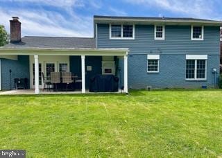 768 Lexington Ave, Hershey, PA 17033 - rear view of house with a patio, a lawn, and a chimney