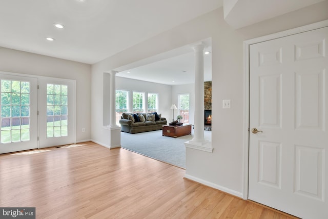 living room with baseboards and ornate columns