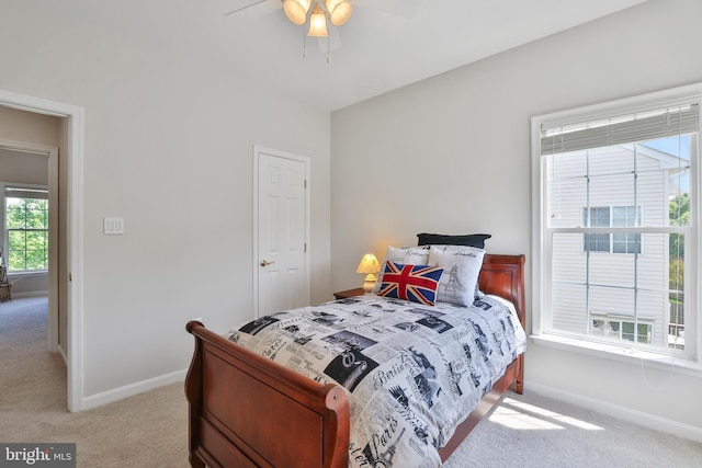 bedroom with baseboards, light carpet, and a ceiling fan
