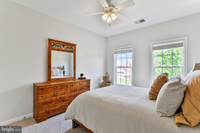bedroom featuring baseboards, a ceiling fan, carpet flooring, and visible vents