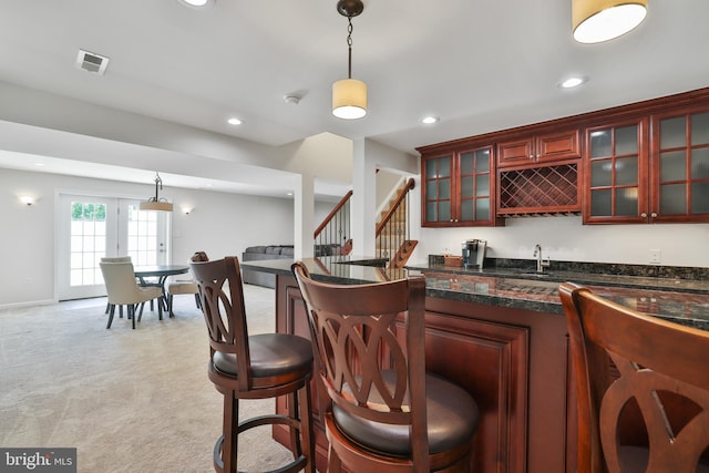 bar featuring pendant lighting, stairway, recessed lighting, and wet bar