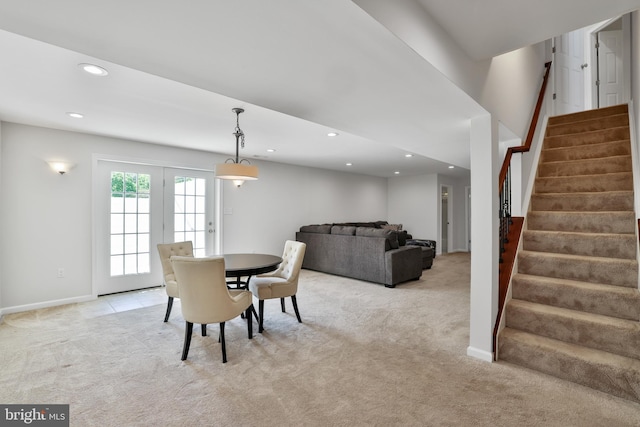 dining space featuring light colored carpet, recessed lighting, baseboards, and stairway