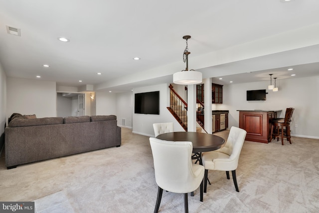 dining area featuring light colored carpet, recessed lighting, stairs, and visible vents