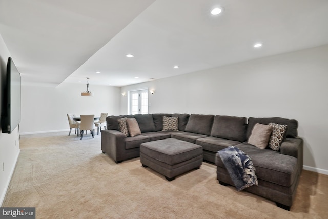 living room with light colored carpet, recessed lighting, and baseboards