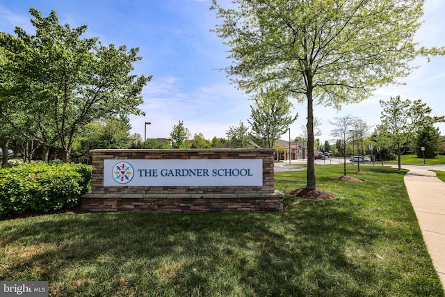 community sign featuring a lawn