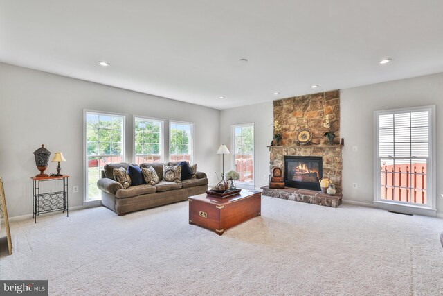 carpeted living area featuring recessed lighting, baseboards, visible vents, and a fireplace