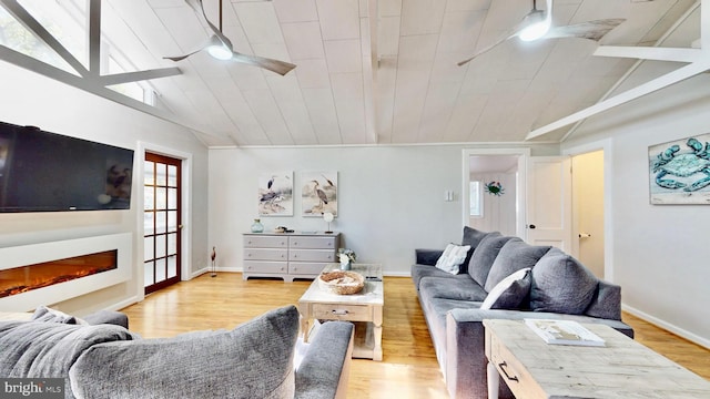 11951 Neale Sound Dr, Cobb Island, MD 20625 - living room with a glass covered fireplace, baseboards, vaulted ceiling, light wood-style flooring, and ceiling fan