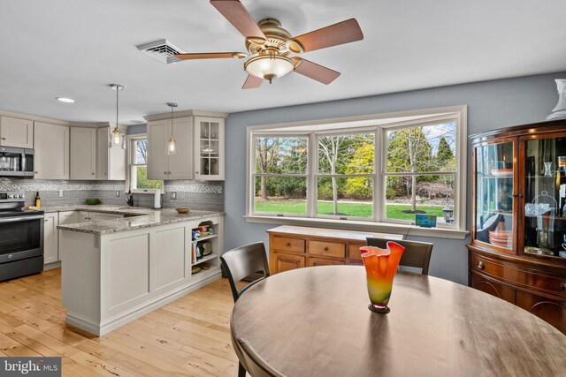 517 Monocacy Hl, Birdsboro, PA 19508 - kitchen featuring stainless steel appliances, hanging light fixtures, glass insert cabinets, and backsplash