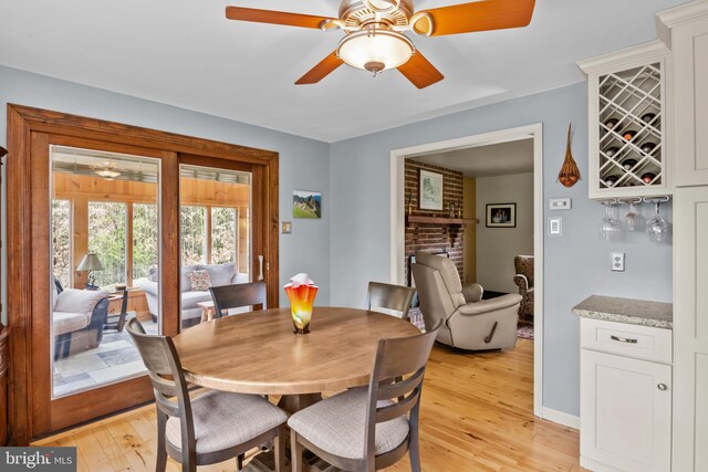 517 Monocacy Hl, Birdsboro, PA 19508 - dining room featuring light wood finished floors, a ceiling fan, a dry bar, and a fireplace
