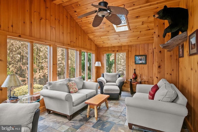 517 Monocacy Hl, Birdsboro, PA 19508 - living room featuring stone tile floors, wood walls, wooden ceiling, lofted ceiling with skylight, and a ceiling fan