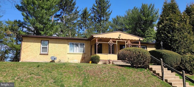 517 Monocacy Hl, Birdsboro, PA 19508 - view of front of house featuring stucco siding, stairway, and a front yard