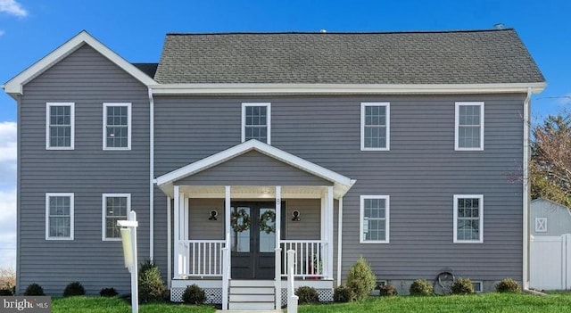 colonial house featuring french doors, a porch, and a shingled roof
