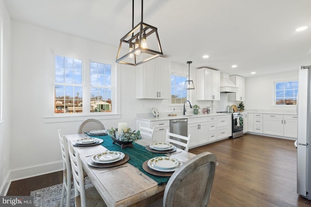 dining space featuring dark wood finished floors, baseboards, plenty of natural light, and recessed lighting