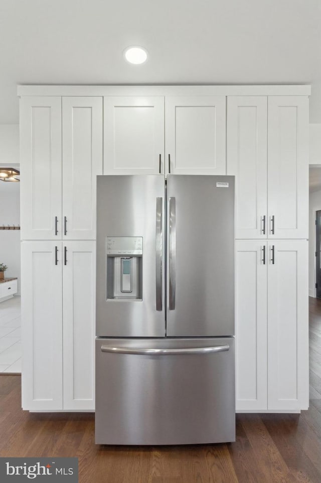 room details featuring white cabinetry, stainless steel refrigerator with ice dispenser, and dark wood-type flooring