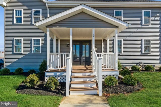 doorway to property with a porch and french doors