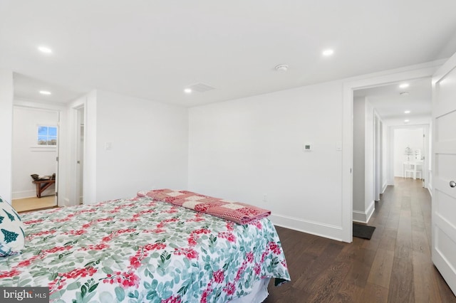bedroom with dark wood-style flooring, baseboards, and recessed lighting