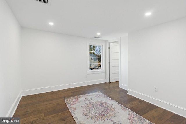 unfurnished room with baseboards, dark wood-style flooring, and recessed lighting