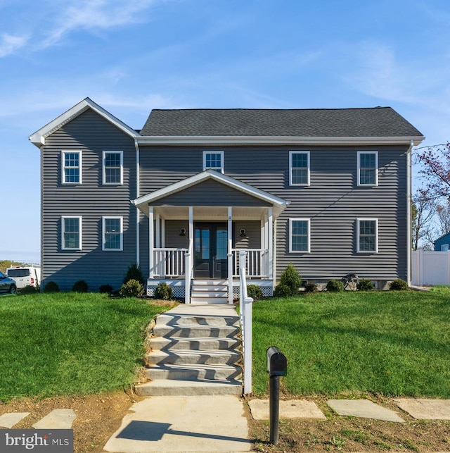 view of front of home with covered porch and a front lawn