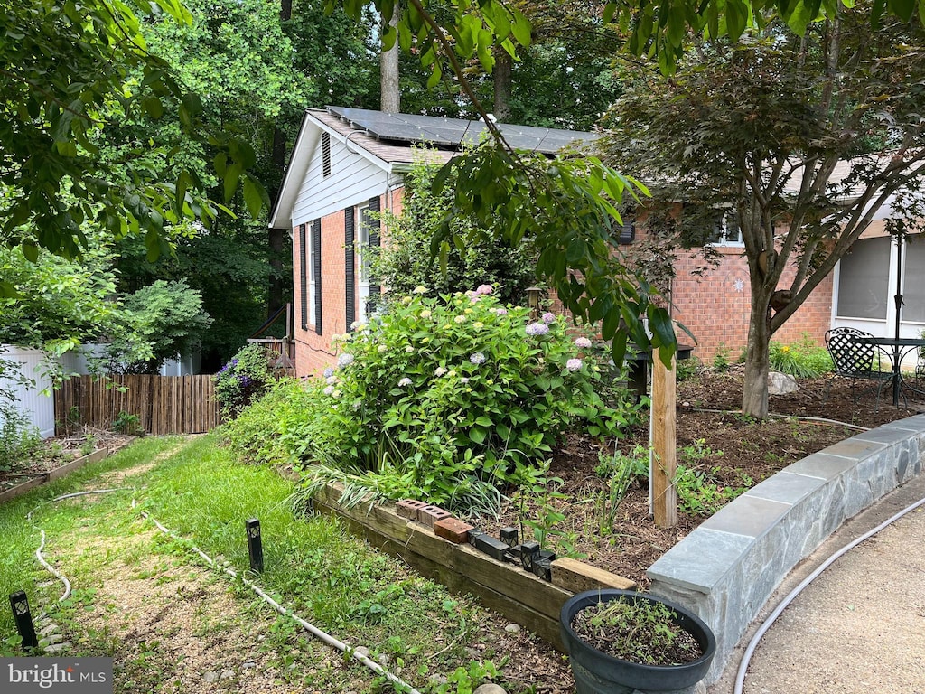 8606 London Ct, Springfield, VA 22151 - view of home's exterior featuring brick siding and roof mounted solar panels