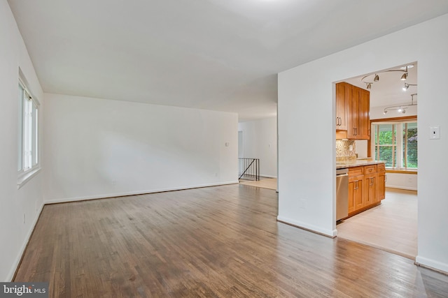 6901 Niles Dr, Laurel, MD 20707 - unfurnished living room with wood finished floors, track lighting, and baseboards
