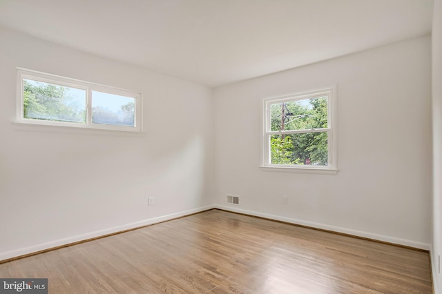 6901 Niles Dr, Laurel, MD 20707 - spare room featuring plenty of natural light, wood finished floors, and baseboards