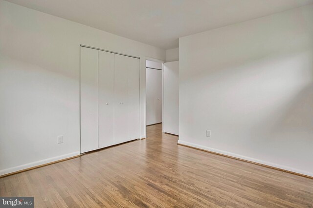 6901 Niles Dr, Laurel, MD 20707 - unfurnished bedroom with wood finished floors, baseboards, and a closet