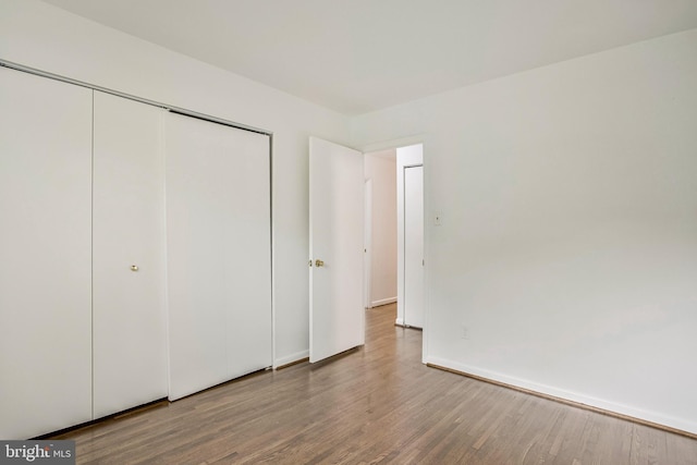 6901 Niles Dr, Laurel, MD 20707 - unfurnished bedroom featuring wood finished floors, a closet, and baseboards
