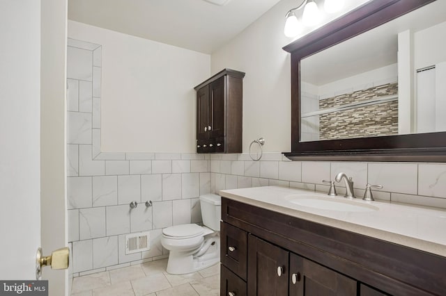 6901 Niles Dr, Laurel, MD 20707 - bathroom with toilet, vanity, tiled shower, tile walls, and tile patterned floors