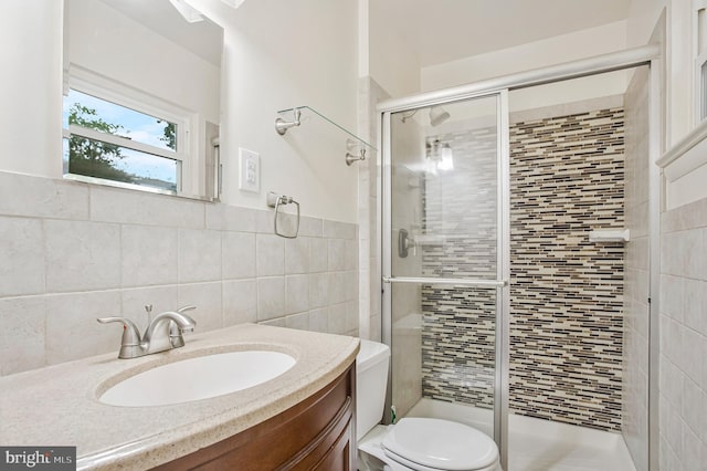 6901 Niles Dr, Laurel, MD 20707 - full bathroom featuring a stall shower, vanity, toilet, and tile walls