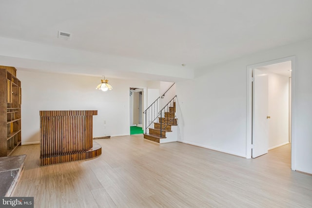 6901 Niles Dr, Laurel, MD 20707 - unfurnished living room featuring wood finished floors, stairs, a dry bar, and baseboards