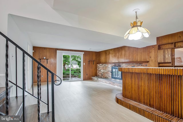 6901 Niles Dr, Laurel, MD 20707 - kitchen featuring wood walls, wood finished floors, and brown cabinetry