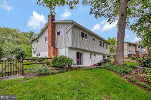 6901 Niles Dr, Laurel, MD 20707 - rear view of property with a chimney and central air condition unit