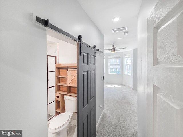 3906 Reisterstown Rd, Baltimore, MD 21215 - hallway featuring a barn door, carpet floors, baseboards, and recessed lighting