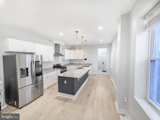 3906 Reisterstown Rd, Baltimore, MD 21215 - kitchen with stainless steel appliances, wall chimney exhaust hood, white cabinets, light wood-type flooring, and light stone countertops