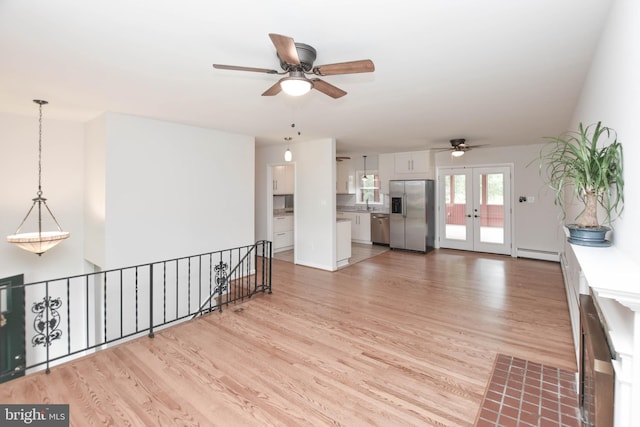 19468 Youngs Cliff Rd, Sterling, VA 20165 - unfurnished living room with ceiling fan, a baseboard heating unit, and light wood-style floors
