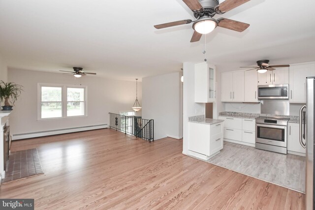 19468 Youngs Cliff Rd, Sterling, VA 20165 - kitchen with appliances with stainless steel finishes, a baseboard heating unit, ceiling fan, light wood finished floors, and white cabinetry