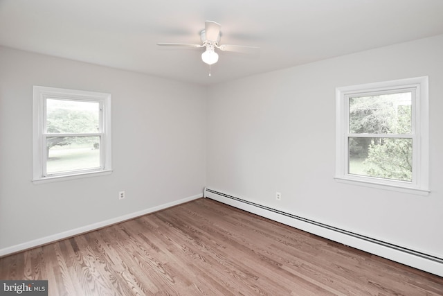 19468 Youngs Cliff Rd, Sterling, VA 20165 - spare room featuring a baseboard heating unit, wood finished floors, ceiling fan, and baseboards