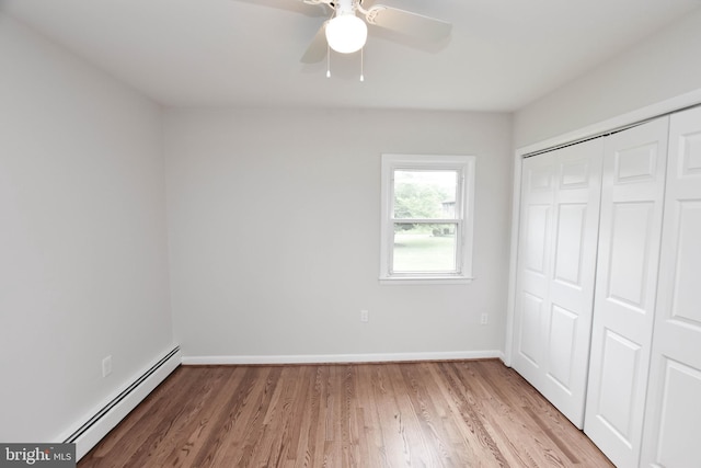 19468 Youngs Cliff Rd, Sterling, VA 20165 - unfurnished bedroom with baseboard heating, light wood-style floors, a closet, baseboards, and a ceiling fan