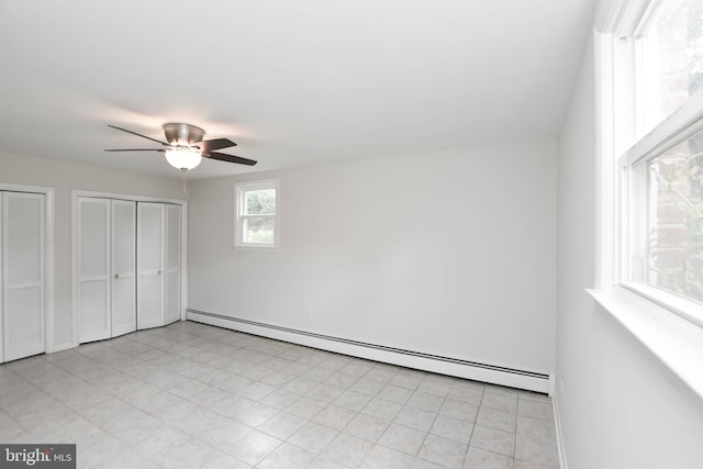 19468 Youngs Cliff Rd, Sterling, VA 20165 - unfurnished bedroom with baseboard heating, multiple closets, a ceiling fan, and baseboards