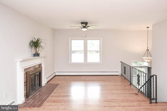 19468 Youngs Cliff Rd, Sterling, VA 20165 - unfurnished living room featuring a baseboard radiator, a ceiling fan, wood finished floors, and a fireplace with flush hearth