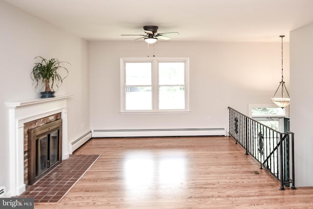 19468 Youngs Cliff Rd, Sterling, VA 20165 - unfurnished living room featuring a ceiling fan, plenty of natural light, a fireplace with flush hearth, and wood finished floors